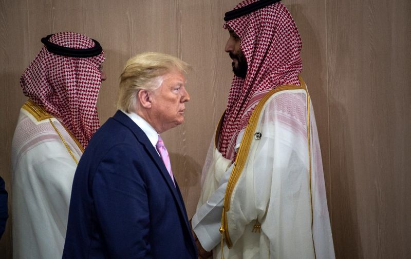 US President Donald Trump and Saudi Arabia's Crown Prince Mohammed Bin Salman (R) arrive for a meeting on "World Economy" at the G20 Summit in Osaka on June 28, 2019. (Photo by Eliot BLONDET / POOL / AFP)