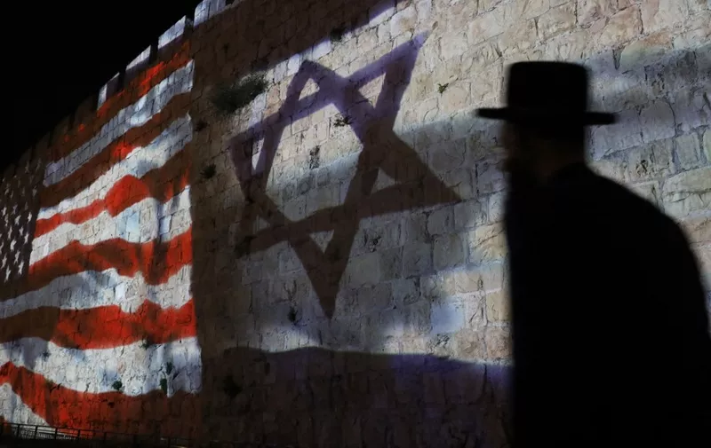 The Israeli and United States flags are projected on the walls of the ramparts of Jerusalem's Old City, to mark one year since the transfer of the US Embassy from Tel Aviv to Jerusalem on May 15, 2019. (Photo by AHMAD GHARABLI / AFP)