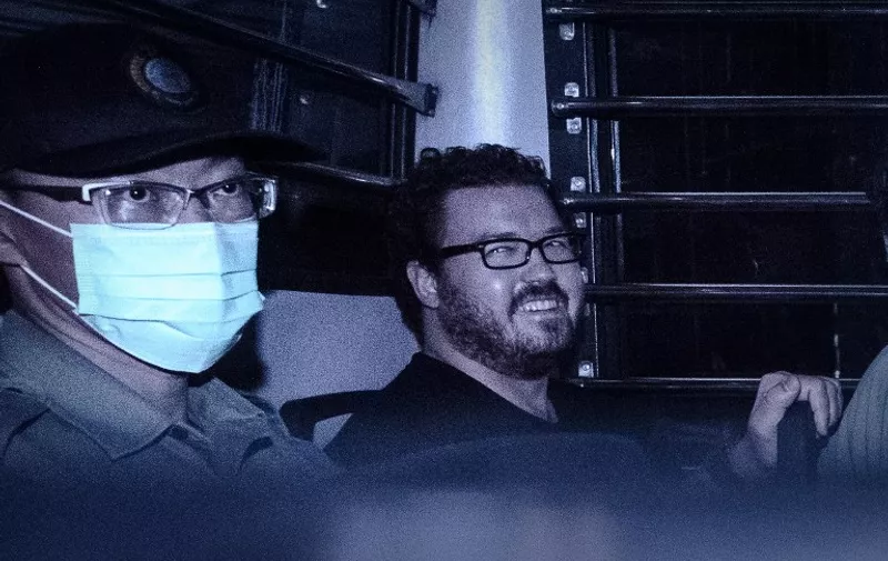 (FILES) This file photo taken on November 10, 2014 shows British banker Rurik Jutting smiling as he sits in a prison van leaving the eastern court in Hong Kong.
British banker Jutting was found guilty on November 8, 2016 of the murder of two Indonesian women after a Hong Kong jury finished its deliberations. / AFP PHOTO / PHILIPPE LOPEZ