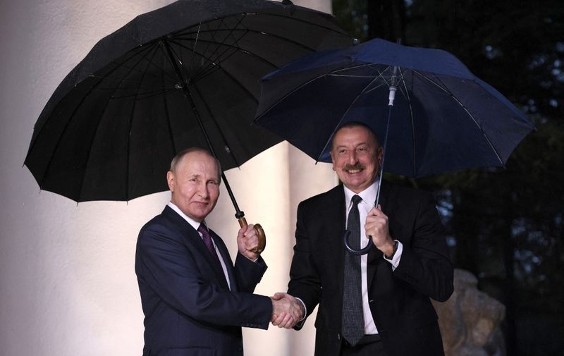 Russian President Vladimir Putin welcomes Azeri President Ilham Aliyev for talks prior to a meeting of Russian President with the leaders of Armenia and Azerbaijan in the Black Sea resort city of Sochi on October 31, 2022. (Photo by Sergei BOBYLYOV / SPUTNIK / AFP)