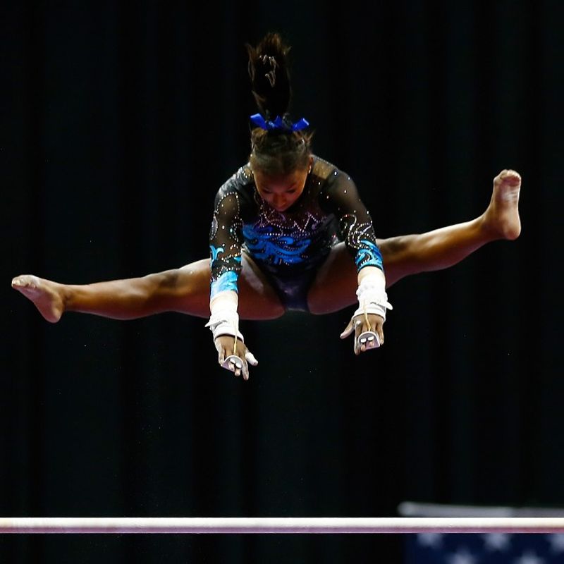 PITTSBURGH, PA - AUGUST 21: Nia Dennis competes on the bars in the junior women preliminaries during the 2014 P&amp;G Gymnastics Championships at Consol Energy Center on August 21, 2014 in Pittsburgh, Pennsylvania.   Jared Wickerham/Getty Images/AFP