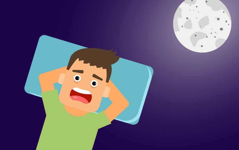 Young man with light brown hair, who wears a green blouse, is in the moonlight and cannot sleep, has an expression of anguish from insomnia,Image: 642354267, License: Royalty-free, Restrictions: , Model Release: yes
