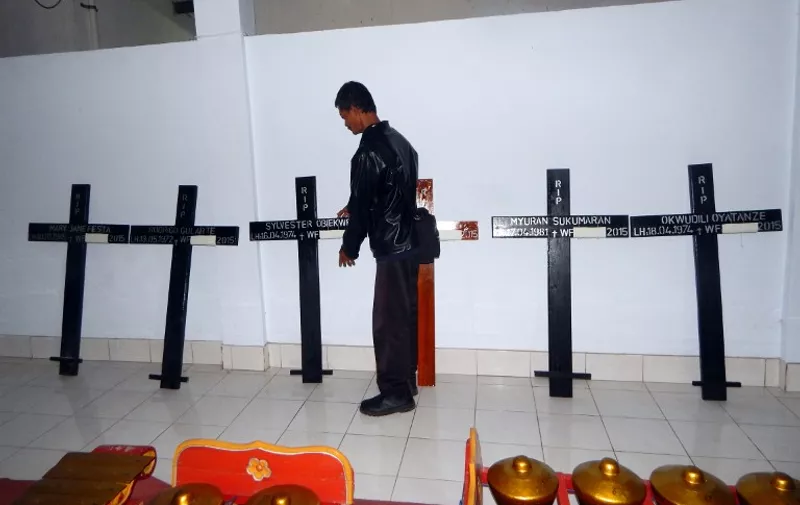 A caretaker handles crosses for condemned drug convicts following their completion at a church in Cilacap on April 28, 2015, ahead of the convicts' imminent execution at the Nusakambangan maximum security prison island. Indonesia made final preparations April 28 to execute eight foreigners by firing squad, as family members wailed in grief during last visits to their loved ones and ambulances carrying white coffins arrived at the drug convicts' prison. AFP PHOTO / AZKA