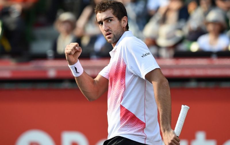 Marin Cilic of Croatia reacts after breaking a service game of Kei Nishikori of Japan during their quarter-final match at the Japan Open tennis tournament in Tokyo on October 9, 2015.      AFP PHOTO / Toru YAMANAKA