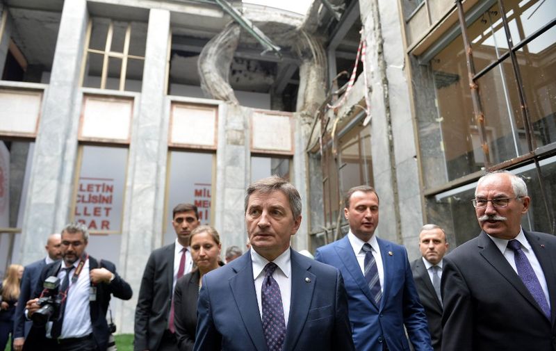 Marshal of the Sejm (Polish Parliament) Marek Kuchcinski (C) visits the Grand National Assembly of Turkey (TBMM), which was damaged during the failed July 15 military coup attempt, after his meeting with its speaker in Ankara on October 27, 2016. (Photo by STRINGER / AFP)