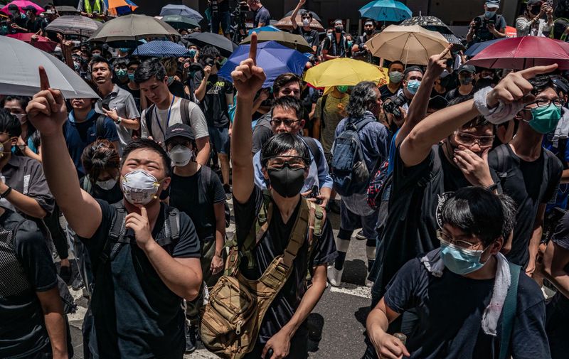 HONG KONG, HONG KONG - JUNE 21: Protesters shout slogans as they demonstrate on a street outside the Hong Kong Police Headquarters on June 21, 2019 in Hong Kong, China. Hong Kong pro-democracy activist, Joshua Wong, said on Monday after being released from jail that Chief Executive Carrie Lam must step down as he joined protesters against the controversial extradition bill which would allow suspected criminals to be sent to the mainland and place its citizens at risk of extradition to China. (Photo by Anthony Kwan/Getty Images)