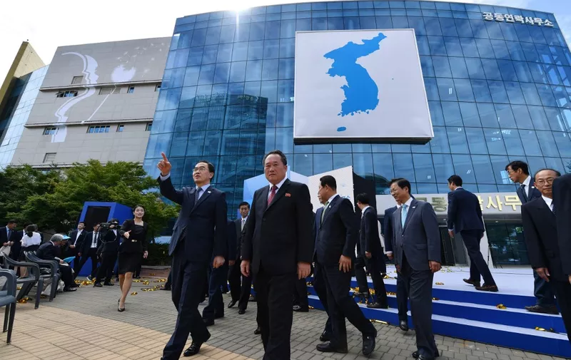 South Korean unification minister Cho Myoung-gyon (L from C) and his North Korean counterpart Ri Son Gwon (C) attend an opening ceremony of a joint liaison office in Kaesong, North Korea, on September 14, 2018. - North and South Korea opened a joint liaison office in the Northern city of Kaesong on September 14, as they knit closer ties ahead of President Moon Jae-in's visit to Pyongyang next week. (Photo by - / KOREA POOL / AFP) / South Korea OUT