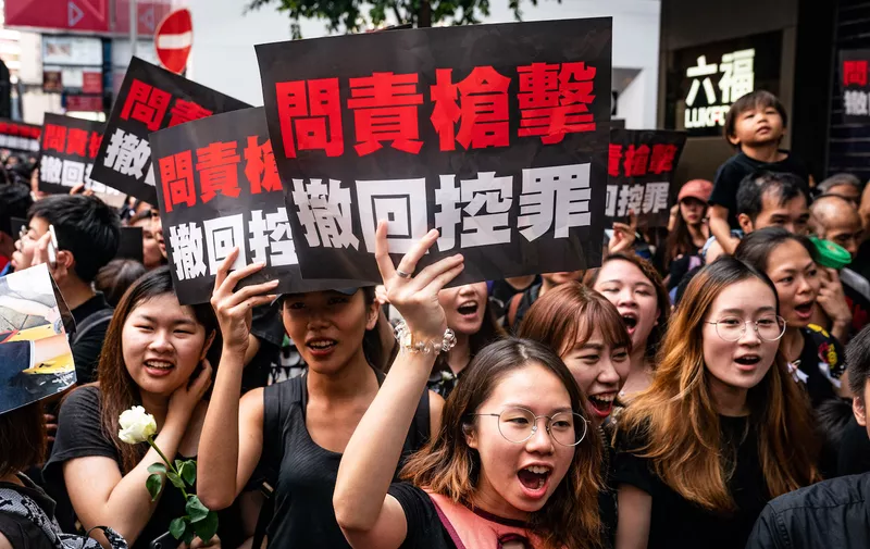 HONG KONG, HONG KONG - JUNE 16:  Protesters hold banners and shout slogans as they march on a street on June 16, 2019 in Hong Kong China. Large numbers of protesters rallied on Sunday despite an announcement yesterday by Hong Kong's Chief Executive Carrie Lam that the controversial extradition bill will be suspended indefinitely. (Photo by Anthony Kwan/Getty Images)