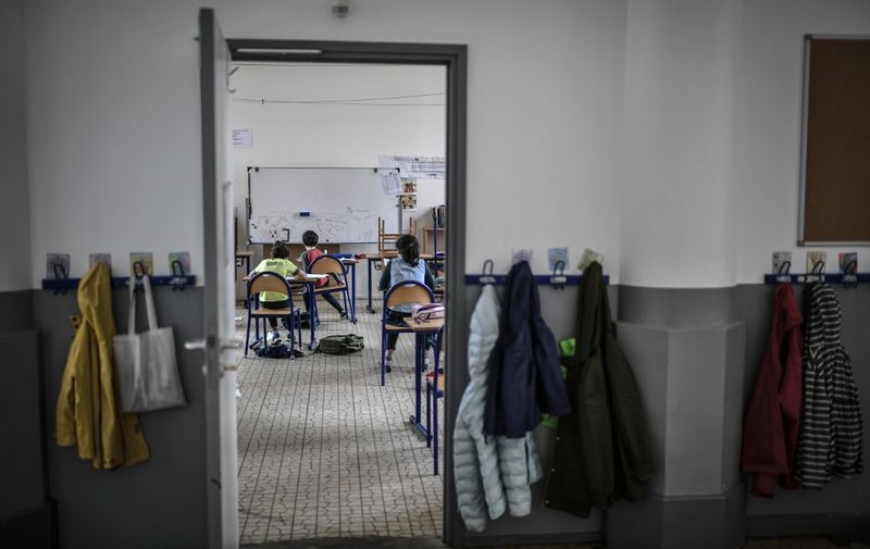 Children of medical staff members are pictures in the classroom at the Eugene Napoleon Saint-Pierre Fourier private school on April 30, 2020, in Paris, on the 45th day of a strict lockdown in France to stop the spread of COVID-19 (novel coronavirus). (Photo by STEPHANE DE SAKUTIN / AFP)