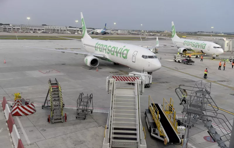 Two Transavia Boeing 737-8K2 (800) are pictured parked to gates on the tarmac prior to the first flight departure on the day of the re-opening of Paris' Orly airport on June 26, 2020. (Photo by ERIC PIERMONT / AFP)