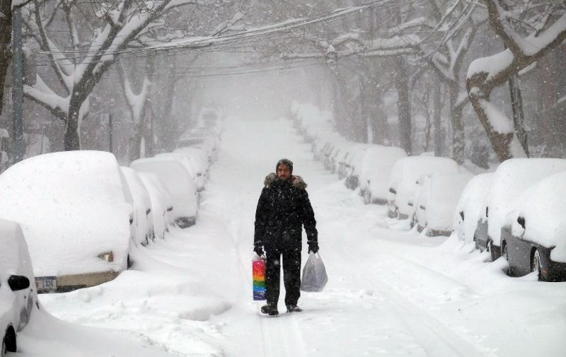 A man makes his way during a storm in New York on January 23, 2016.
A deadly blizzard walloped the eastern US on January 23, paralyzing the capital and other cities under a heavy blanket of snow as officials warned millions of people to remain indoors until the storm eases up. At least eight people were killed in three states in road accidents, officials said, as snow piled up from Arkansas to New York. Forecasters said the storm -- dubbed "Snowzilla" -- would last into Sunday as it moved menacingly up the coast.
 / AFP / Jewel Samad