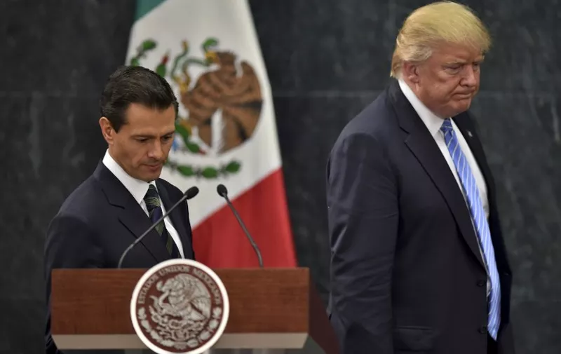 US presidential candidate Donald Trump (R) and Mexican President Enrique Pena Nieto prepare to deliver a joint press conference in Mexico City on August 31, 2016.
Donald Trump was expected in Mexico Wednesday to meet its president, in a move aimed at showing that despite the Republican White House hopeful's hardline opposition to illegal immigration he is no close-minded xenophobe. Trump stunned the political establishment when he announced late Tuesday that he was making the surprise trip south of the border to meet with President Enrique Pena Nieto, a sharp Trump critic.
 / AFP PHOTO / YURI CORTEZ