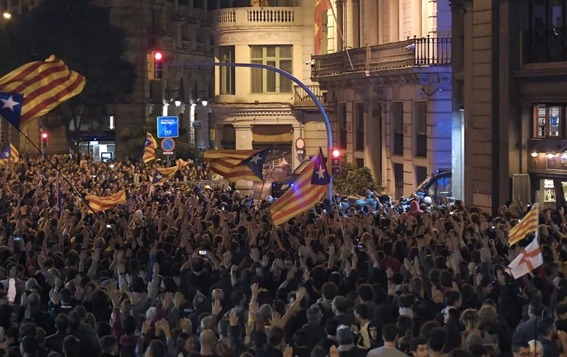 Pro-independence protesters, called by the local Republic Defence Committees (CDR), surround the Spanish police headquarters in Barcelona, on October 26, 2019. - Previously, around 350,000 people rallied in downtown Barcelona today, turning the streets into a sea of independence flags in the latest mass protest against Spain's jailing of nine separatist leaders. (Photo by LLUIS GENE / AFP)