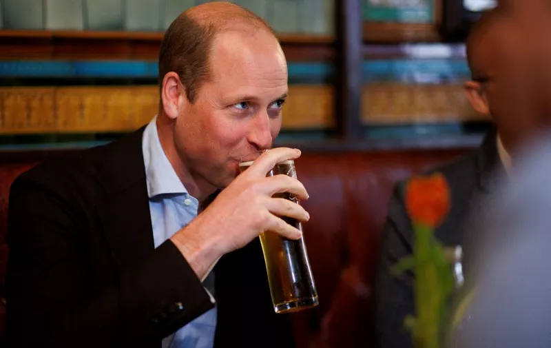 Britain's Prince William, Prince of Wales drinks a beer as he visits the Dog &amp; Duck Pub in Soho, central London, on May 4, 2023 to hear about their preparation for the Coronation Weekend and meet members of staff and representatives from other hospitality and recreation businesses of the area. (Photo by Jamie Lorriman / POOL / AFP)