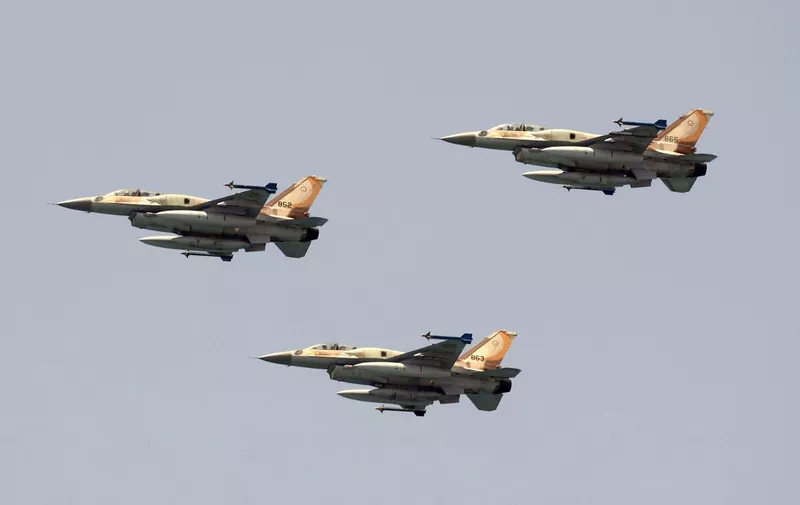 Israeli F-16 fighter jets perform during an air show over the beach in the Israeli coastal city of Tel Aviv on May 5, 2022, as Israel marks Independence Day (Yom HaAtzmaut), 74 years since the establishment of the Jewish state. - Israel's first prime minister David Ben-Gurion declared the existence of the State of Israel in Tel Aviv in 1948, ending the British mandate. (Photo by JACK GUEZ / AFP)