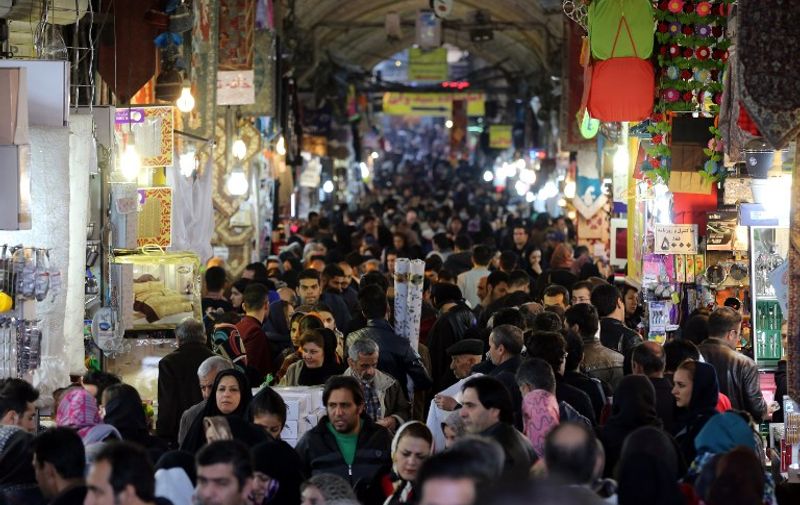 Iranians shop in Tehran's ancient Grand Bazaar on January 16, 2016. 
Iran's Foreign Minister Mohammad Javad Zarif said nuclear-related sanctions on his country would be lifted on January 16, 2016, telling reporters in Vienna it "was a good day for the world".



 / AFP / ATTA KENARE