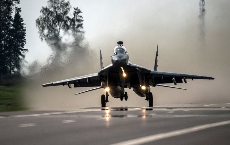 Belarus Military Air Force MIG-29 jet fighter makes a landing on the Minsk - Mahiley highway during a special training session some 70 km, east of Minsk on September 10, 2014. PHOTO / STRINGER (Photo by STRINGER / AFP)