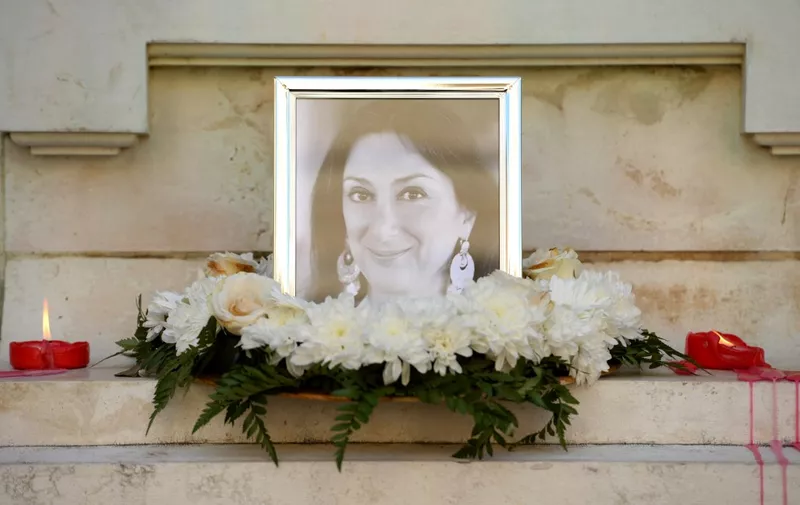 Flowers and tributes lay at the foot of the Great Siege monument in Valletta, Malta, on October 19, 2017 which has been turned into a temporary shrine for Maltese journalist and blogger Daphne Caruana Galizia (picture) who was killed by a car bomb outside her home in Bidnjia, Malta, on October 16, 2017. (Photo by Matthew Mirabelli / AFP) / Malta OUT