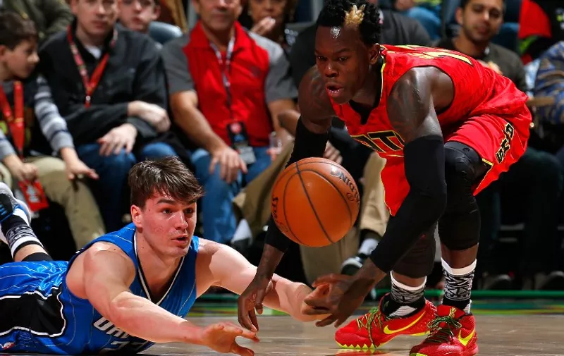 ATLANTA, GA - JANUARY 18: Mario Hezonja #23 of the Orlando Magic saves a loose ball against Dennis Schroder #17 of the Atlanta Hawks at Philips Arena on January 18, 2016 in Atlanta, Georgia. NOTE TO USER User expressly acknowledges and agrees that, by downloading and or using this photograph, user is consenting to the terms and conditions of the Getty Images License Agreement.   Kevin C. Cox/Getty Images/AFP