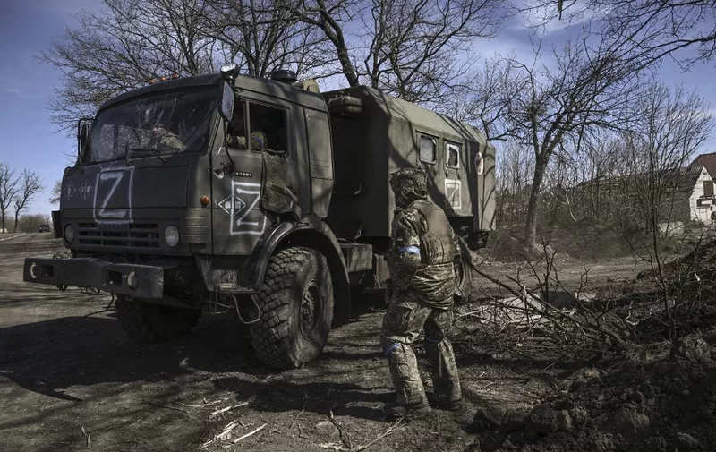 Ukranian troops drive a captured Russian military vehicle after retaken the village of Mala Rogan, East of Kharkiv, on March 28, 2022. (Photo by Aris Messinis / AFP)