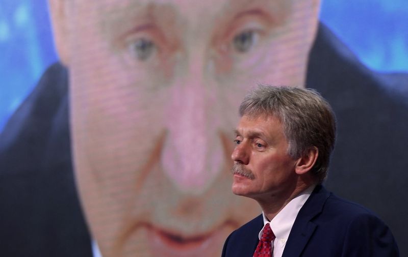 (FILES) In this file photo taken on December 17, 2020, Kremlin spokesman Dmitry Peskov sits in front of a screen displaying Russian President Vladimir Putin addressing his annual press conference via a video link from the Novo-Ogaryovo state residence, at the World Trade Centre's congress centre in Moscow. - Russia would only use nuclear weapons in the context of the Ukraine conflict if it were facing an "existential threat," Kremlin spokesman Dmitry Peskov told CNN International on March 22, 2022. (Photo by NATALIA KOLESNIKOVA / AFP)
