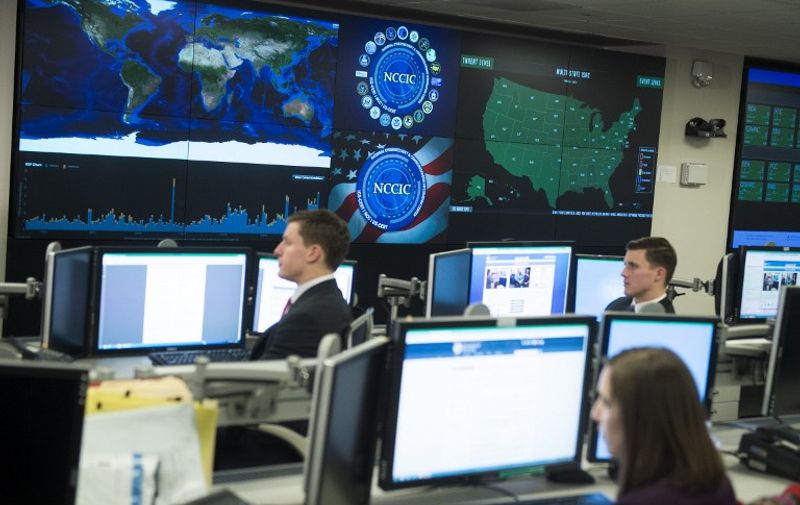Staff members sit at their work stations at the National Cybersecurity and Communications Integration Center in Arlington, Virginia, January 13, 2015. US President Barack Obama visited the facility to talk about cyber security. AFP PHOTO / SAUL LOEB