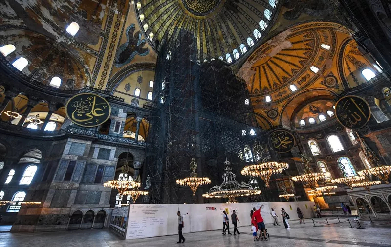 People visit the Hagia Sophia museum in Istanbul, on July 10, 2020. - Turkey's top court considered whether Istanbul's emblematic landmark and former cathedral Hagia Sophia can be redesignated as a mosque, a ruling which could inflame tensions with the West. (Photo by Ozan KOSE / AFP)