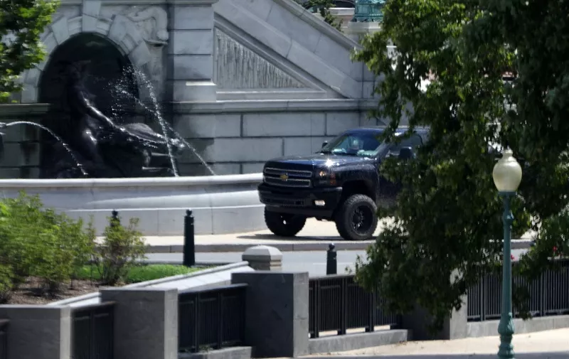 WASHINGTON, DC - AUGUST 19: A pickup truck sits outside the Library of Congress, directly across from the U.S. Capitol, on Capitol Hill August 19, 2021 in Washington, DC. A man drove a pickup truck onto the sidewalk outside the Library this morning telling police officers that he had a bomb. Authorities have evacuated the surrounding areas and going through negotiation with the suspect.   Alex Wong/Getty Images/AFP (Photo by ALEX WONG / GETTY IMAGES NORTH AMERICA / Getty Images via AFP)