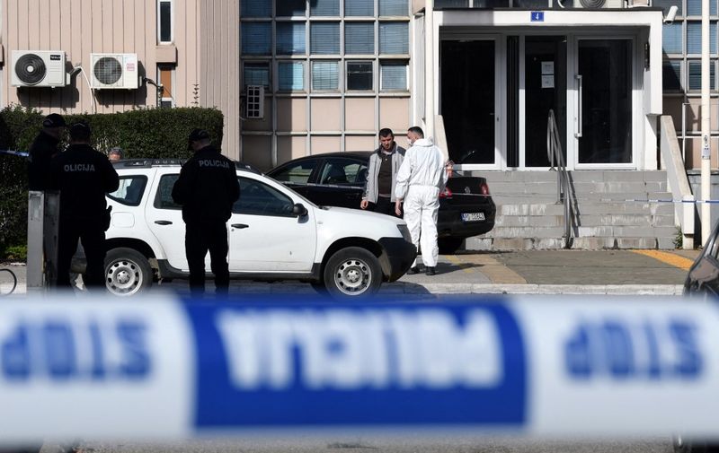 Montenegrin police officers and investigators stand at the entrance to Podgorica County Court, on March 3, 2023. A suicide bomber detonated an explosive device inside the courthouse on March 3, killing himself and injuring 8 persons, two of whom sustained life threatening injuries. The incident happened at Montenegro's Basic Court, a lower judiciary body that handles municipal cases in the capital. (Photo by SAVO PRELEVIC / AFP)