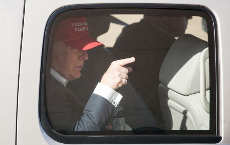 LYNDEN, WA - MAY 07: Republican presidential candidate Donald Trump gestures from his motorcade after a rally at the The Northwest Washington Fair and Event Center on May 7, 2016 in Lynden, Washington. Trump became the Republican presumptive nominee following his landslide win in Indiana on Tuesday.   Matt Mills McKnight/Getty Images/AFP
