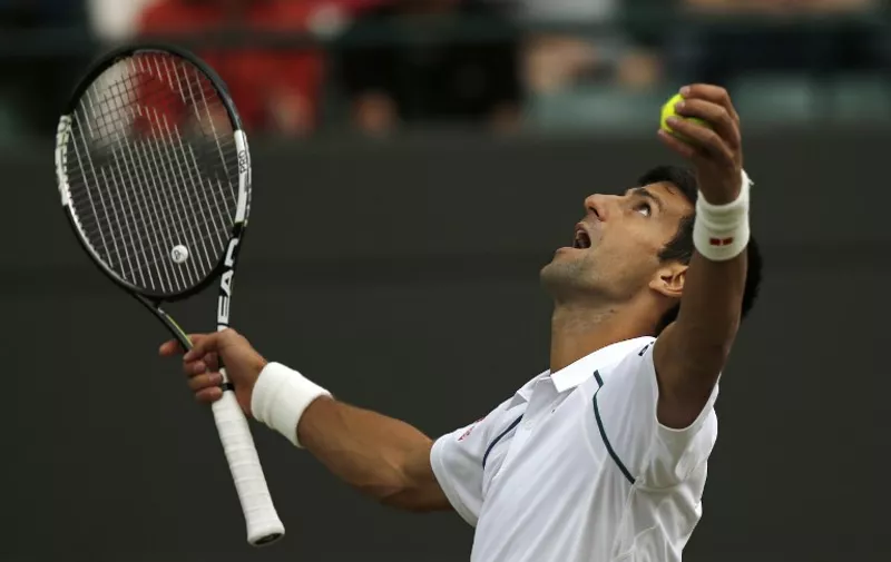 Serbia's Novak Djokovic reacts after serving an ace against South Africa's Kevin Anderson during their men's singles fourth round match on day eight of the 2015 Wimbledon Championships at The All England Tennis Club in Wimbledon, southwest London, on July 7, 2015. RESTRICTED TO EDITORIAL USE  --   AFP PHOTO / ADRIAN DENNIS