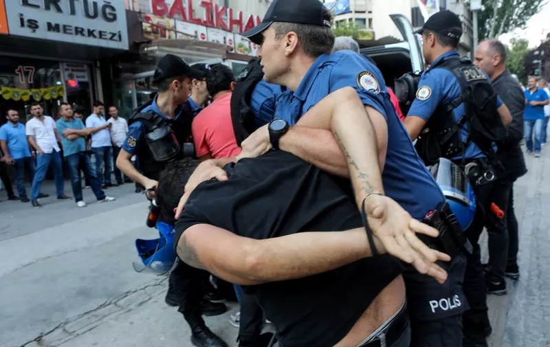 Turkish police officers arrest demonstrators, in Ankara, on July 20, 2018 as they were taking part in a protest rally for the anniversary of the 2015 suicide attack in the southern Turkish town of Suruc. - Leftist youth gathered to protest as they mark the anniversary of a suicide bomb attacks which killed 31 people in Suruc where activists had gathered to prepare for an aid mission to the nearby Syrian town of Kobane. It was one of the deadliest attacks in Turkey in recent years and the first time the government has directly accused the Islamic State group of carrying out an act of terror on Turkish soil. (Photo by ADEM ALTAN / AFP)