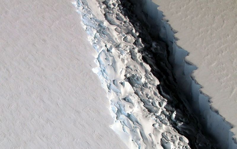 This NASA photo released December 1, 2016 shows what scientists on NASA's IceBridge mission photographed in a view of a massive rift in the Antarctic Peninsula's Larsen C ice shelf on November 10, 2016. 
Ice shelves are the floating parts of ice streams and glaciers, and they buttress the grounded ice behind them; when ice shelves collapse, the ice behind accelerates toward the ocean, where it then adds to sea level rise. Larsen C neighbors a smaller ice shelf that disintegrated in 2002 after developing a rift similar to the one now growing in Larsen C. The IceBridge scientists measured the Larsen C fracture to be about 70 miles long, more than 300 feet wide and about a third of a mile deep. The crack completely cuts through the ice shelf but it does not go all the way across it  once it does, it will produce an iceberg roughly the size of the state of Delaware. / AFP PHOTO / NASA / NASA/Maria-Jose VINAS / RESTRICTED TO EDITORIAL USE - MANDATORY CREDIT AFP PHOTO /NASA/Maria-Jose Vinas  - NO MARKETING - NO ADVERTISING CAMPAIGNS - DISTRIBUTED AS A SERVICE TO CLIENTS