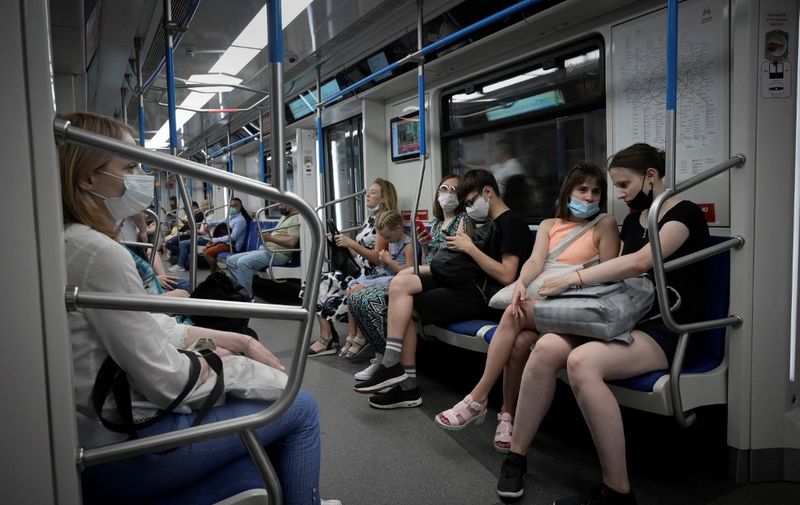 Passengers sit in the subway, in Moscow on June 27, 2021, amid the ongoing Covid-19 pandemic. - Moscow on June 27, 2021 recorded the worst daily coronavirus death toll so far for a Russian city, as countries across the Asia-Pacific region extended or reimposed restrictions to tackle fresh waves of infections. (Photo by Natalia KOLESNIKOVA / AFP)