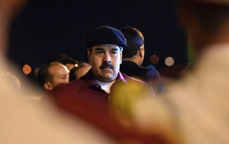 Venezuelan President Nicolas Maduro arrives at the Houari Boumedien Airport in Algiers for a two-day visit on September 10, 2017.
Maduro is visiting fellow oil exporter Algeria days after announcing his country would sell crude in non-dollar currencies in a bid to resist US sanctions. / AFP PHOTO / RYAD KRAMDI / RYAD KRAMDI