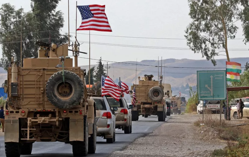 A convoy of US military vehicles arrives near the Iraqi Kurdish town of Bardarash in the  Dohuk governorate after withdrawing from northern Syria on October 21, 2019. (Photo by SAFIN HAMED / AFP)