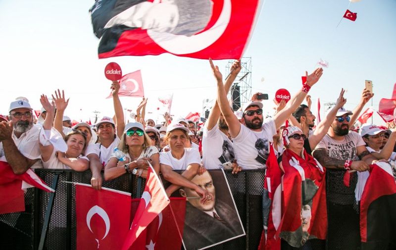Supporters of Turkey's main opposition Republican People's Party (CHP) leader Kemal Kilicdaroglu cheer and wave flags during a rally in Istanbul on July 9, 2017, marking the end of a 450-kilometre (280 mile) "justice march" from Ankara to Istanbul. 
The rally marks the end of a 450-kilometre (280 mile) "justice march" from Ankara to Istanbul by Republican People's Party (CHP) leader Kemal Kilicdaroglu, who launched an unprecedented trek on June 15 in protest the arrest of one of his MPs.  / AFP PHOTO / GURCAN OZTURK
