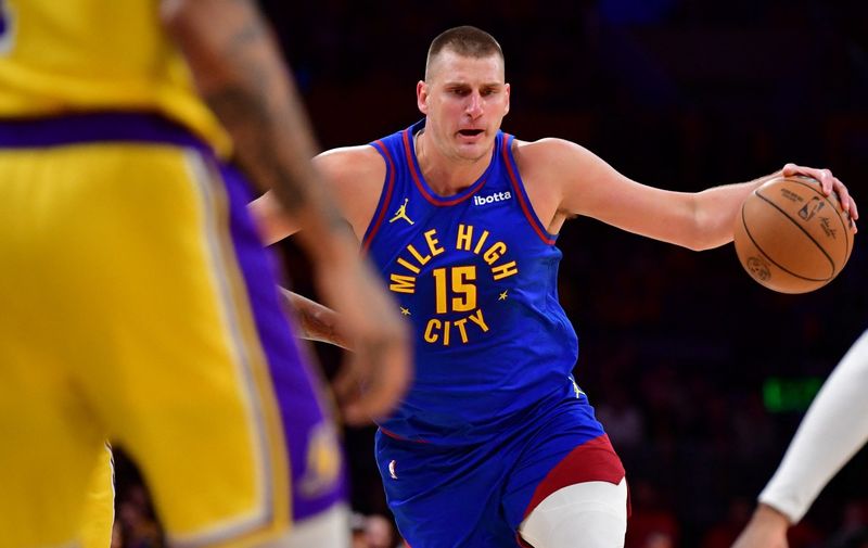 Apr 25, 2024; Los Angeles, California, USA; Denver Nuggets center Nikola Jokic (15) moves to the basket against the Los Angeles Lakers during the first half in game three of the first round for the 2024 NBA playoffs at Crypto.com Arena. Mandatory Credit: Gary A. Vasquez-USA TODAY Sports