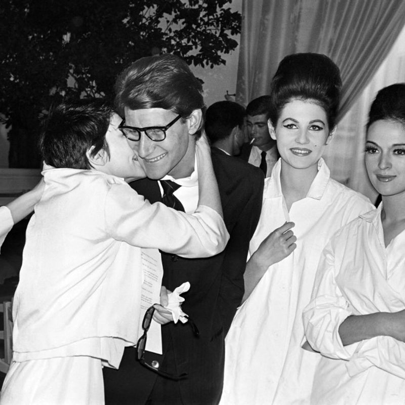 French dancer Zizi Jeanmaire (L) kisses designer Yves Saint-Laurent on July 30, 1962 after the presentation of the Haute couture fashion show in Paris. (Photo by AFP)
