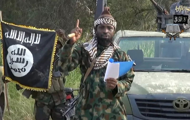 (FILES) -- A file picture of a screengrab taken on October 2, 2014 from a video released by the Nigerian Islamist group Boko Haram and obtained by AFP shows Boko Haram leader, Abubakar Shekau gesturing as he delivers a speech. The leader of Nigeria's Boko Haram denied he had been killed or ousted as chief of the jihadist group in an audio recording released on August 15, 2015 attributed to him by security experts. In the eight-minute Hausa-language message, Abubakar Shekau rebuffed claims by Chadian leader Idriss Deby that he had been replaced and called the president a "hypocrite" and a "tyrant".  AFP PHOTO / HO / BOKO HARAM
= RESTRICTED TO EDITORIAL USE - MANDATORY CREDIT "AFP PHOTO / BOKO HARAM" - NO MARKETING NO ADVERTISING CAMPAIGNS - DISTRIBUTED AS A SERVICE TO CLIENTS =