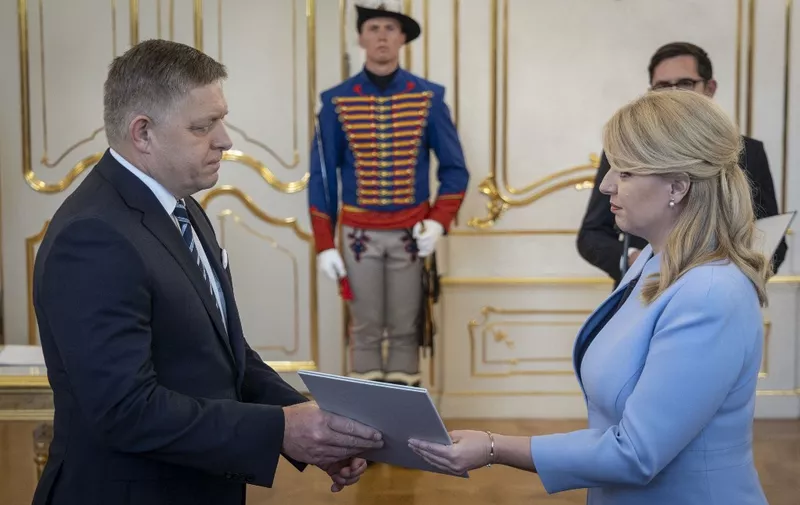 (FILES) Slovakia's President Zuzana Caputova (R) hands over a document to Robert Fico at the Presidential Palace in Bratislava, Slovakia, during the appointment of a new government on October 25, 2023. Slovak President Zuzana Caputova condemned a "brutal and reckless" attack on Prime Minister Robert Fico on May 15, 2024, following reports that he had been shot. "I am shocked. I wish Robert Fico a lot of strength in this critical moment to recover from the attack," she said in a statement, calling it "a brutal and reckless attack". (Photo by TOMAS BENEDIKOVIC / AFP)