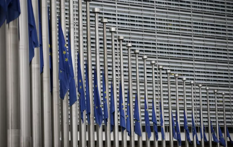 European flags fly at half mast in front of the headquarters of the European Commission in Brussels on March 23, 2016, a day after triple bomb attacks in the Belgian capital killed about 35 people and left more than 200 people wounded. A series of explosions claimed by the Islamic State group ripped through Brussels airport and a metro train on March 22, killing around 35 people in the latest attacks to bring bloody carnage to the heart of Europe.  AFP PHOTO / KENZO TRIBOUILLARD / AFP / KENZO TRIBOUILLARD