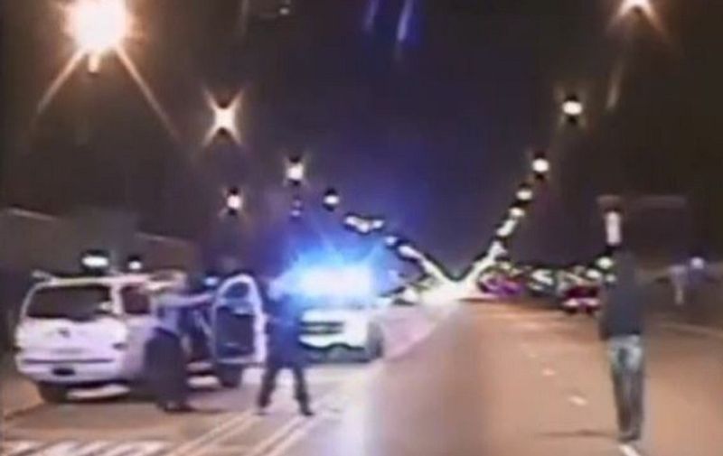 In this screen grab from a video released by the Chicago Police on November 24, 2015, Laquan McDonald (R) looks at police,  before being shot, in Chicago, Illinois on October 24, 2014. Chicago's mayor appealed for calm as officials released a "chilling" video of the police shooting of a black teen, hours after the white officer was charged with murder. The Chicago dashcam video shows officer Jason Van Dyke opening fire on Laquan McDonald, 17, as he walks down the middle of the street. McDonald can be seen walking away from Van Dyke. His body then spins and strikes the pavement. He lifts his head, moves an arm and then a cloud from another gunshot rises up from his chest as he lays in a fetal position.  AFP PHOTO /CHICAGO POLICE/HANDOUT 

= RESTRICTED TO EDITORIAL USE / MANDATORY CREDIT: "AFP PHOTO /CHICAGO POLICE/HANDOUT "/ NO MARKETING / NO ADVERTISING CAMPAIGNS / DISTRIBUTED AS A SERVICE TO CLIENTS = / AFP / CHICAGO POLICE / CHICAGO POLICE