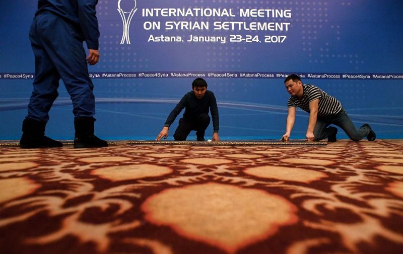 A picture taken on January 22, 2017 shows men at work to prepare the Syria peace talks conference room at Astana' Rixos President Hotel.
The talks, set to begin on Monday, will be the first time a delegation composed exclusively of rebel groups will negotiate with the regime of Syrian President Bashar al-Assad. / AFP PHOTO / Kirill KUDRYAVTSEV