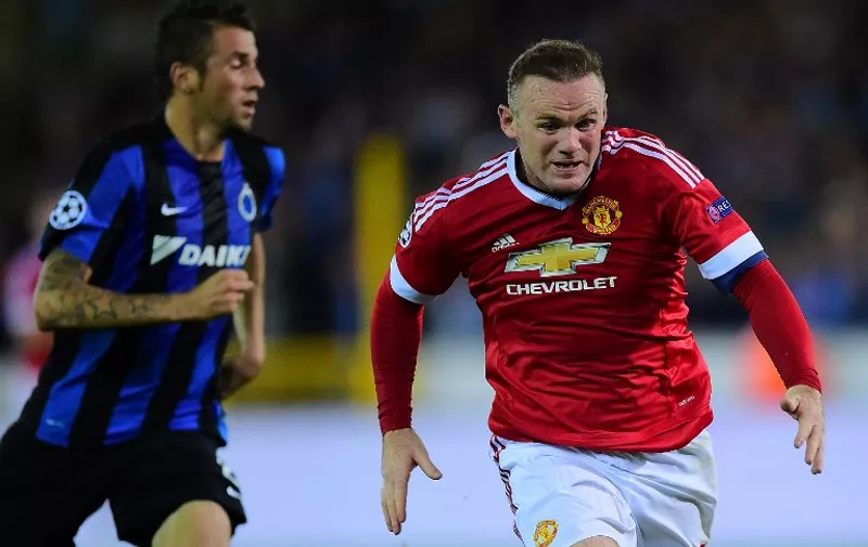 Manchester United's Wayne Rooney (R) controls the ball next to Club Brugge's Claudemir during the UEFA Champions League playoff football match between Club Brugge and Manchester United at Jan Breydel Stadium in Bruges, August 26, 2015. AFP PHOTO / EMMANUEL DUNAND