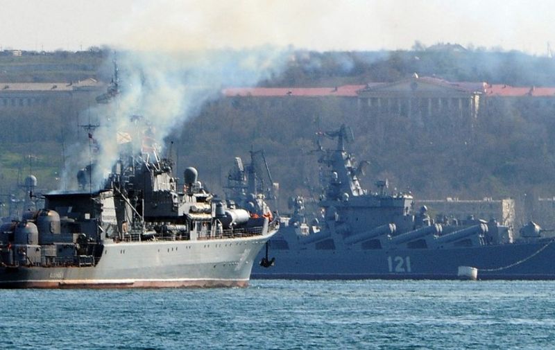 (FILES) In this file photo taken on March 30, 2014 the Russian navy patrol ship 'Pytliviy' (L) navigates near the Russian Navy flagship missile cruiser 'Moskva' (R) docked in the bay of the Crimean city of Sevastopol. - The Moskva, a Russian warship in the Black Sea, was "seriously damaged" by an ammunition explosion, Russian state media said on April 14, 2022. (Photo by AFP)