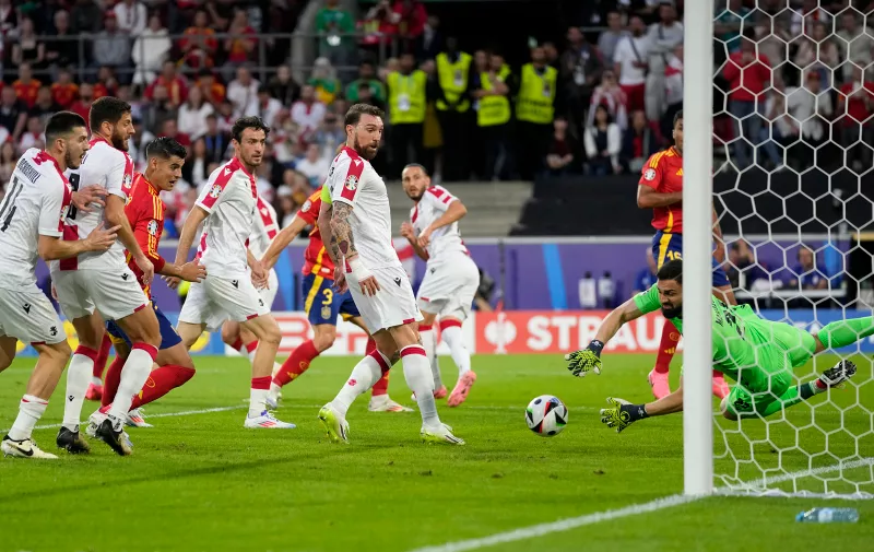 Georgia's goalkeeper Giorgi Mamardashvili jumps to save a goal during a round of sixteen match between Spain and Georgia at the Euro 2024 soccer tournament in Cologne, Germany, Sunday, June 30, 2024. (AP Photo/Darko Vojinovic)