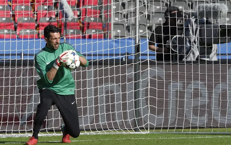 Juventus' goalkeeper and captain Gianluigi Buffon makes a save as he takes part in a training session at the Olympic Stadium in Berlin on June 5, 2015 on the eve of the UEFA Champions League Final football match between Juventus Torino and FC Barcelona.   AFP PHOTO / LLUIS GENE