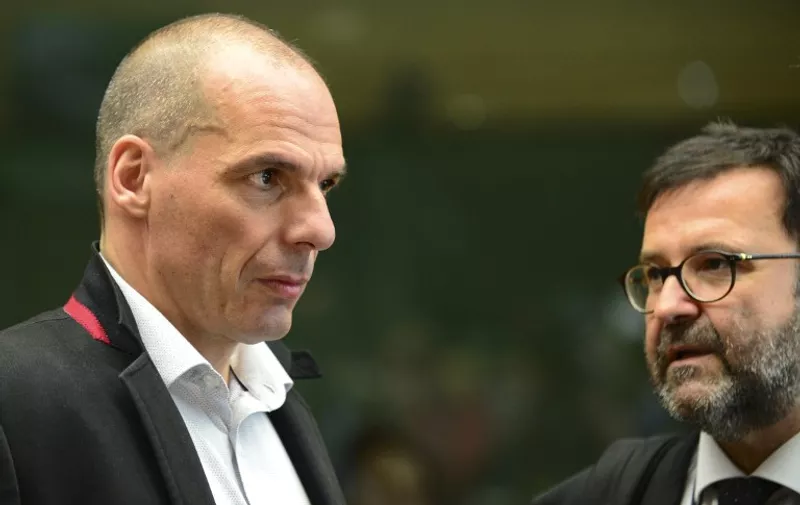 Greek Finance Minister Yanis Varoufakis (L) talks with an advisor before a Eurogroup Council meeting on June 24, 2015  at the EU Headquarters in Brussels. AFP PHOTO / JOHN THYS