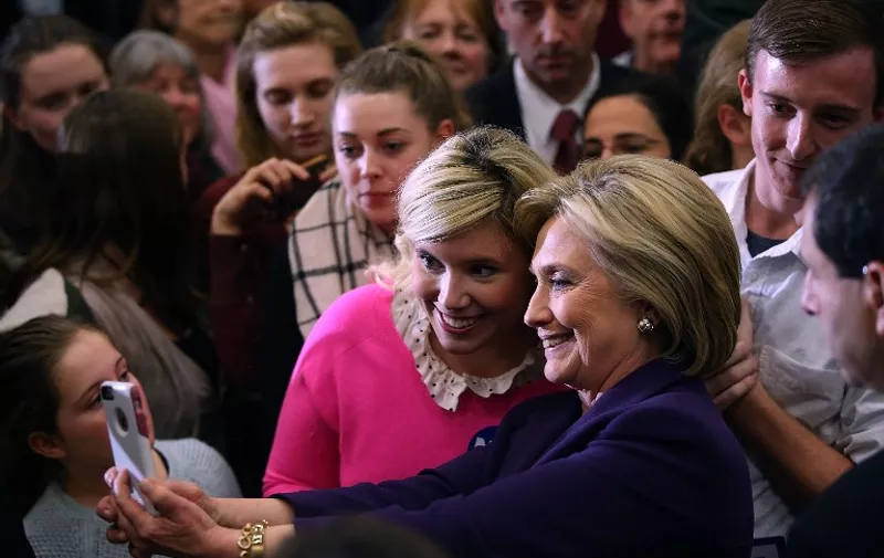HAMPTON, NH - FEBRUARY 02: Democratic presidential candidate former Secretary of State Hillary Clinton takes a selfie with a supporter during a "get out the vote" event at Winnacunnet High School on February 2, 2016 in Hampton, New Hampshire. A day after narrowly defeating democratic candidate Sen. Bernie Sanders (I-VT), Hillary Clinton is campaigning in New Hampshire a week ahead of the state's primary.   Justin Sullivan/Getty Images/AFP